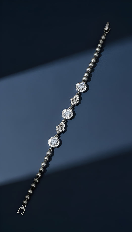 Silver bracelet with diamond-like beads on a dark blue background