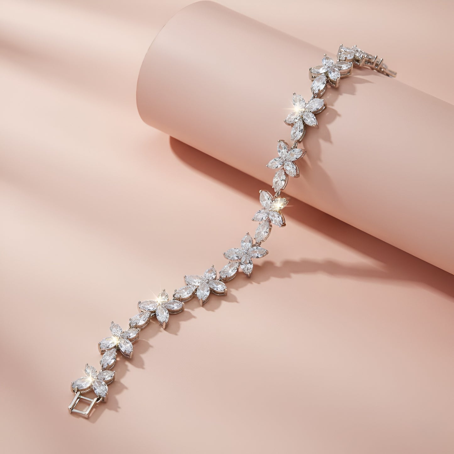 Silver bracelet with floral design on a pink background