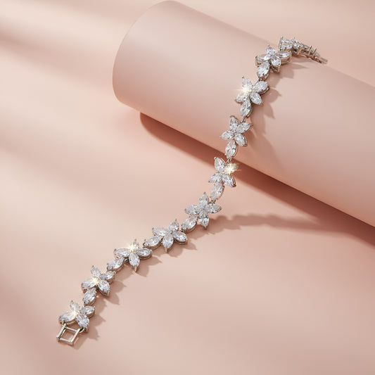 Silver bracelet with floral design on a pink background