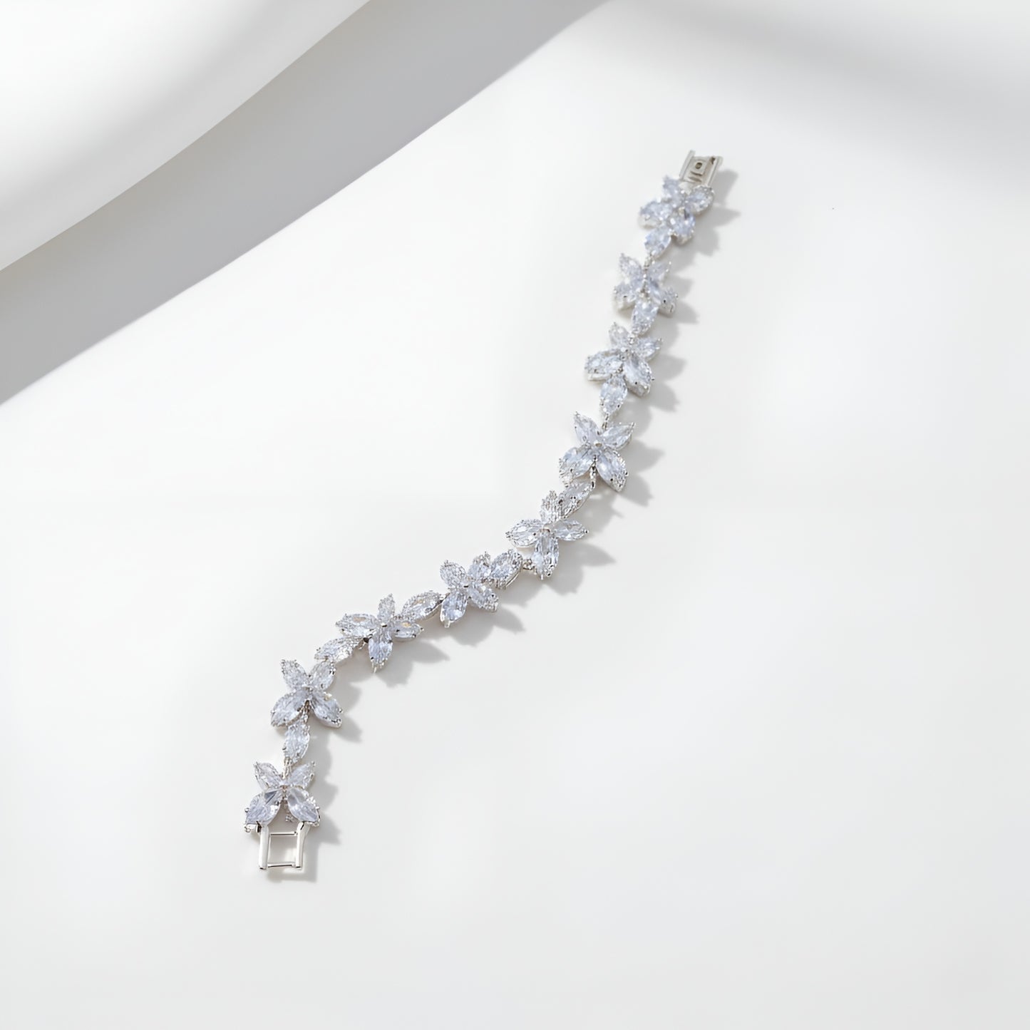 Silver bracelet with clear stones on a white background