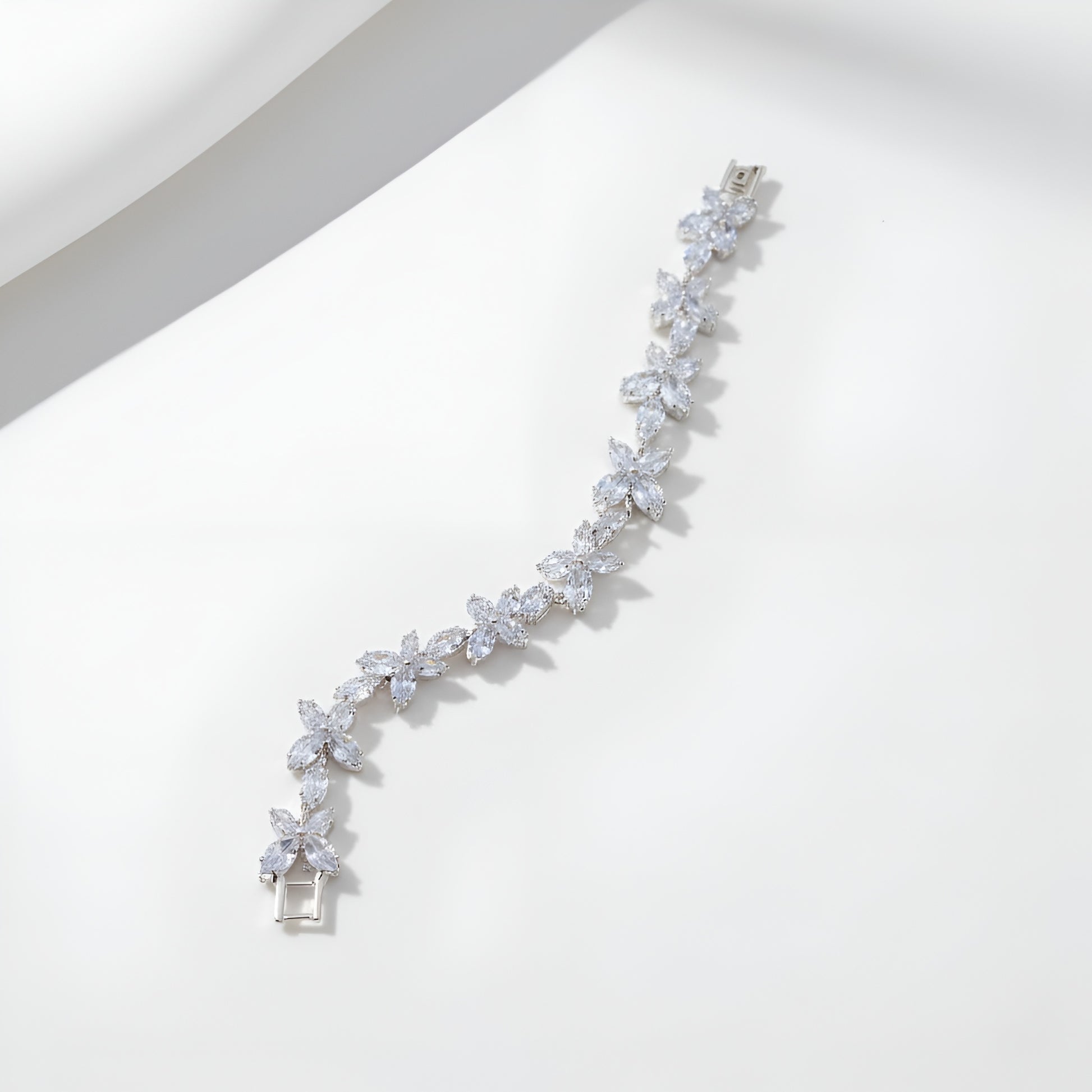 Silver bracelet with clear stones on a white background