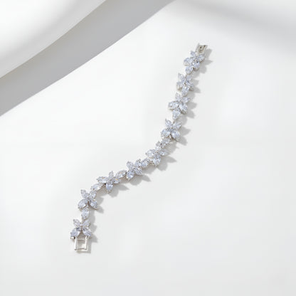 Silver bracelet with clear stones on a white background